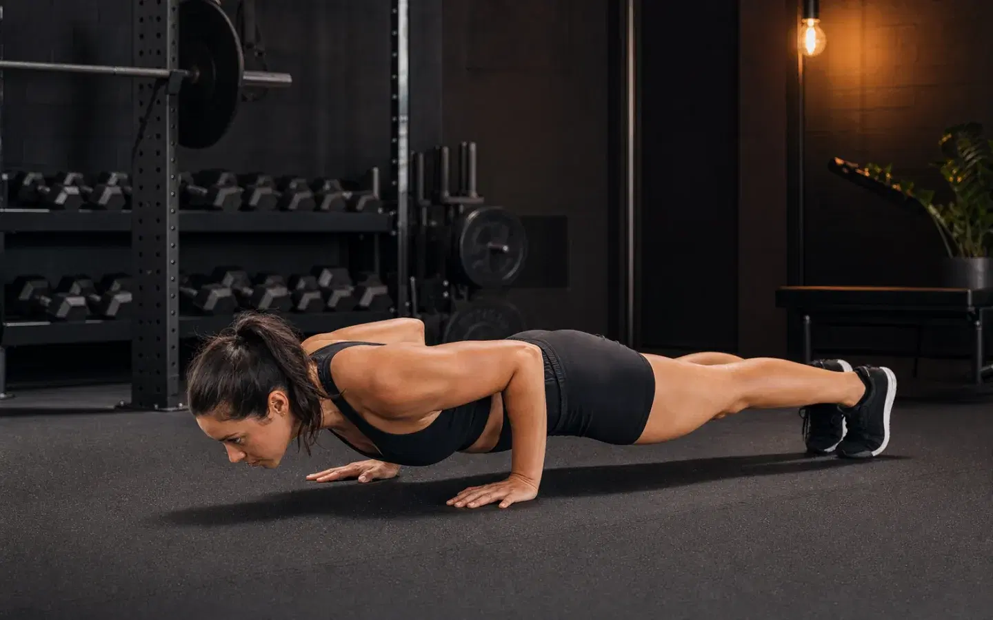 Athlete holding a straight body line near the bottom of a push-up.